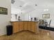 An open kitchen featuring an island, wood cabinets and black appliances at 1060 Davenport Dr, The Villages, FL 32162