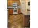 A lovely kitchen with a range, microwave and custom countertops at 1060 Davenport Dr, The Villages, FL 32162