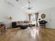 Spacious living room with tile flooring, a ceiling fan, and large windows offering ample natural light at 1060 Davenport Dr, The Villages, FL 32162