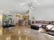 Open-concept living area with tile floors, a breakfast bar, and a seamless flow into the kitchen and dining spaces at 1060 Davenport Dr, The Villages, FL 32162