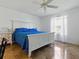 Relaxing main bedroom with blue bedding, a ceiling fan, and a window at 1060 Davenport Dr, The Villages, FL 32162