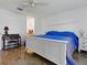 A view of the main bedroom featuring a desk, dresser, and white trim at 1060 Davenport Dr, The Villages, FL 32162