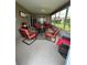 Inviting screened porch featuring comfortable seating and neutral flooring at 1060 Davenport Dr, The Villages, FL 32162