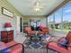Charming sunroom with plenty of natural light, comfortable seating and sliding door access to outdoors at 1060 Davenport Dr, The Villages, FL 32162