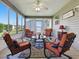 Enclosed sunroom with comfortable seating, large windows, and bright, natural light at 1060 Davenport Dr, The Villages, FL 32162