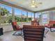 Relaxing sunroom offering great views, equipped with comfortable seating and a ceiling fan at 1060 Davenport Dr, The Villages, FL 32162