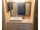 Bathroom with a vanity, sink, mirror, and modern lighting at 1100 Martinique Dr # 105, Winter Haven, FL 33884