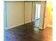 Bedroom with hardwood floors and a mirrored closet at 1100 Martinique Dr # 105, Winter Haven, FL 33884