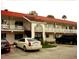 Exterior view of building with balconies, stairs, and parking lot with cars at 1100 Martinique Dr # 105, Winter Haven, FL 33884