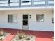 Exterior front of the property featuring a door and windows at 1100 Martinique Dr # 105, Winter Haven, FL 33884