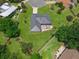 Aerial view showcases the rear patio, and the spacious yard with mature trees around the home at 111 Ridgeview Cir, Eustis, FL 32726