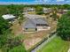 Aerial view of the house showing the metal roof, fenced yard, and outdoor patio area at 111 Ridgeview Cir, Eustis, FL 32726