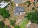 Aerial view of the home showcasing the roof, patio area, and landscaped yard with mature trees at 111 Ridgeview Cir, Eustis, FL 32726