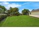 Well-maintained backyard featuring expansive green space and beautiful, mature shade trees at 111 Ridgeview Cir, Eustis, FL 32726