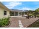 The backyard features a patio, pergola, well-maintained lawn, and tasteful landscaping at 111 Ridgeview Cir, Eustis, FL 32726