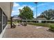 Beautiful backyard featuring a brick patio, pergola, lush lawn, and manicured landscaping at 111 Ridgeview Cir, Eustis, FL 32726