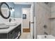 Bathroom featuring a gray vanity, white vessel sink, tub and tiled shower at 111 Ridgeview Cir, Eustis, FL 32726