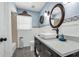 Bathroom featuring gray vanity, white vessel sink and wainscoting at 111 Ridgeview Cir, Eustis, FL 32726