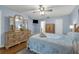 This bedroom features wooden floors, a tray with drinks and a dresser with a large mirror at 111 Ridgeview Cir, Eustis, FL 32726