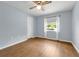 Bright bedroom featuring wood-look floors, neutral paint, and a ceiling fan at 111 Ridgeview Cir, Eustis, FL 32726