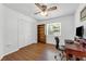 Bedroom with wood floors, ceiling fan, closet, window, and desk at 111 Ridgeview Cir, Eustis, FL 32726