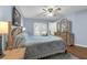 Spacious primary bedroom with blue walls, natural wood furniture, and access to an exterior door at 111 Ridgeview Cir, Eustis, FL 32726