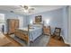 Serene bedroom featuring light blue walls, wood furniture set, ceiling fan, and wood-look flooring at 111 Ridgeview Cir, Eustis, FL 32726