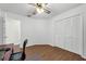 Bedroom featuring wooden floors, ceiling fan, and white closet at 111 Ridgeview Cir, Eustis, FL 32726