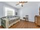 Bedroom with wood floors, ceiling fan, window and single bed at 111 Ridgeview Cir, Eustis, FL 32726