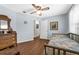 Cozy bedroom features wood-look floors, a ceiling fan, and vintage-style furniture at 111 Ridgeview Cir, Eustis, FL 32726