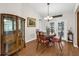 Dining room featuring hardwood floors, a classic china cabinet, and a cozy round table with chairs at 111 Ridgeview Cir, Eustis, FL 32726