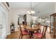 Open concept dining area with hardwood floors, a round table and chairs, connecting to other living spaces at 111 Ridgeview Cir, Eustis, FL 32726