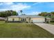 Charming single-story home with a well-manicured lawn, mature trees, and an attached one-car garage at 111 Ridgeview Cir, Eustis, FL 32726