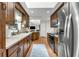 Modern kitchen boasts wood cabinetry, stainless steel appliances, and an open layout connecting to the living area for easy entertaining at 111 Ridgeview Cir, Eustis, FL 32726