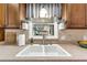 Close-up of kitchen sink with wood cabinets, tiled backsplash, and a window providing natural light and outdoor views at 111 Ridgeview Cir, Eustis, FL 32726