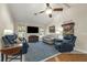 Bright living room featuring vaulted ceilings, comfortable seating, large television, and neutral-colored walls at 111 Ridgeview Cir, Eustis, FL 32726