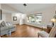 Sunlit living room with large windows, hardwood floors, and neutral walls providing a spacious and relaxing atmosphere at 111 Ridgeview Cir, Eustis, FL 32726