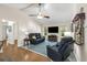 Spacious living room with vaulted ceilings, large TV, comfortable seating, and neutral decor at 111 Ridgeview Cir, Eustis, FL 32726