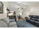 Inviting living room with vaulted ceilings, ceiling fan, stylish furniture, and open flow to dining area and kitchen at 111 Ridgeview Cir, Eustis, FL 32726