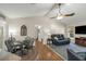 Open living space with vaulted ceilings, dining area, modern furnishings, and view into hallway at 111 Ridgeview Cir, Eustis, FL 32726