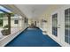 Covered patio with blue carpeting and exterior doors; inviting for outdoor relaxation at 111 Ridgeview Cir, Eustis, FL 32726