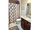 Bathroom featuring vanity with dark wood cabinets, granite counters, a shower with curtain, and a toilet at 11277 Se 170Th Ln, Summerfield, FL 34491