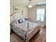 Bedroom with a white four-poster bed, ceiling fan, and window letting in natural light at 11277 Se 170Th Ln, Summerfield, FL 34491