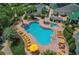 Inviting community pool area with ample seating, lush landscaping, and a relaxing spa at 11277 Se 170Th Ln, Summerfield, FL 34491