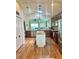 Bright kitchen with stainless appliances, granite counters, center island, and pass-through to living area at 11277 Se 170Th Ln, Summerfield, FL 34491
