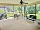 Screened patio with dining table and chairs and a bench offering a relaxing outdoor space at 11277 Se 170Th Ln, Summerfield, FL 34491