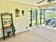 Screened patio with outdoor grill, custom wall art, and a place to relax at 11277 Se 170Th Ln, Summerfield, FL 34491