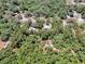 Aerial view of a wooded parcel of land outlined in red at 1203 High St, Wildwood, FL 34785