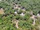 Aerial view of a wooded parcel of land outlined in red at 1203 High St, Wildwood, FL 34785