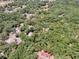 Aerial view of a wooded parcel of land outlined in red at 1203 High St, Wildwood, FL 34785